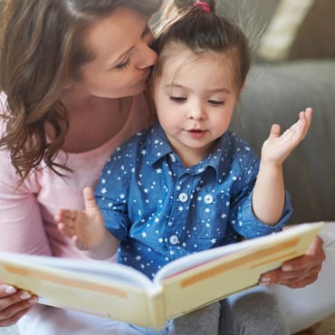 A woman and child reading a book